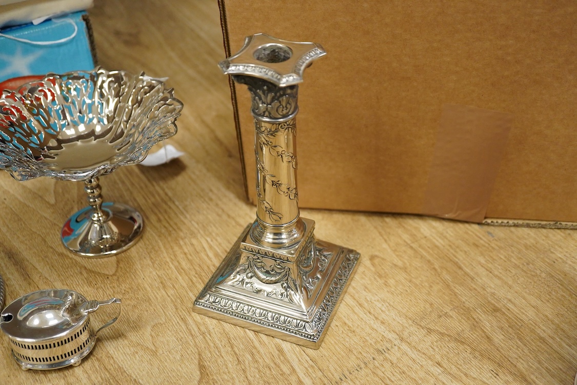 Assorted plated wares including a pair of candlesticks and a casserole dish.